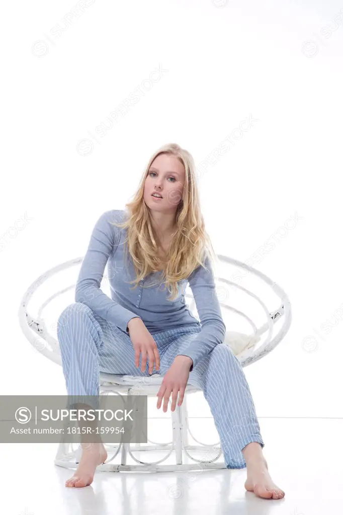 Blond young woman relaxing in papasan chair