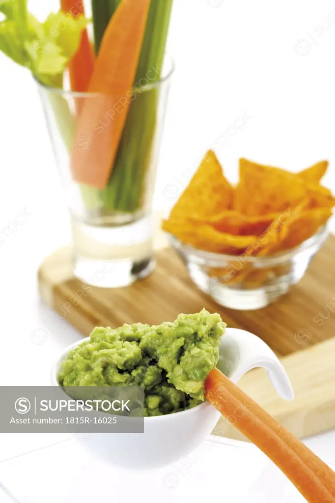Guacamole with vegetable sticks and tortilla chips