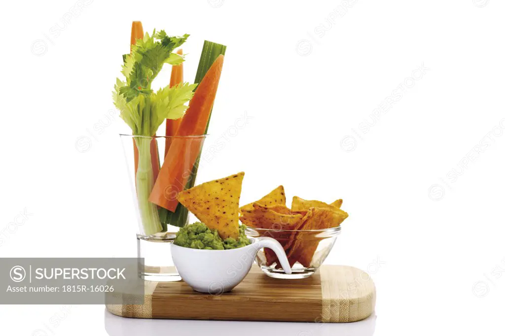 Guacamole with vegetable sticks and tortilla chips