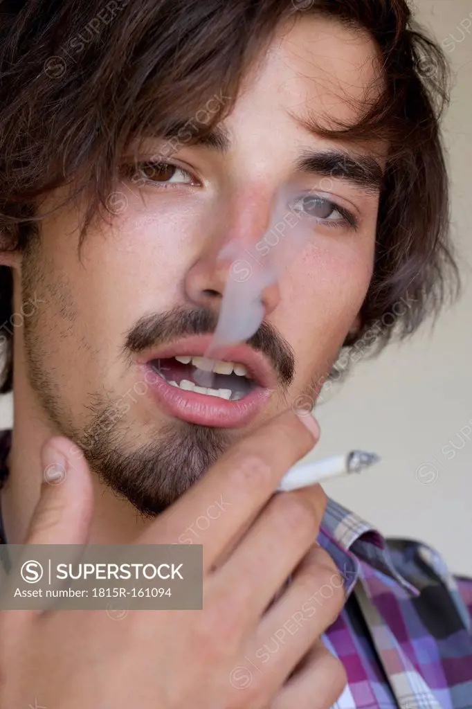 Portrait of smoking young man