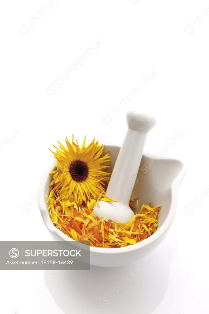 Marigold blossoms (Calendula officinalis) in Mortar with pestle, elevated view