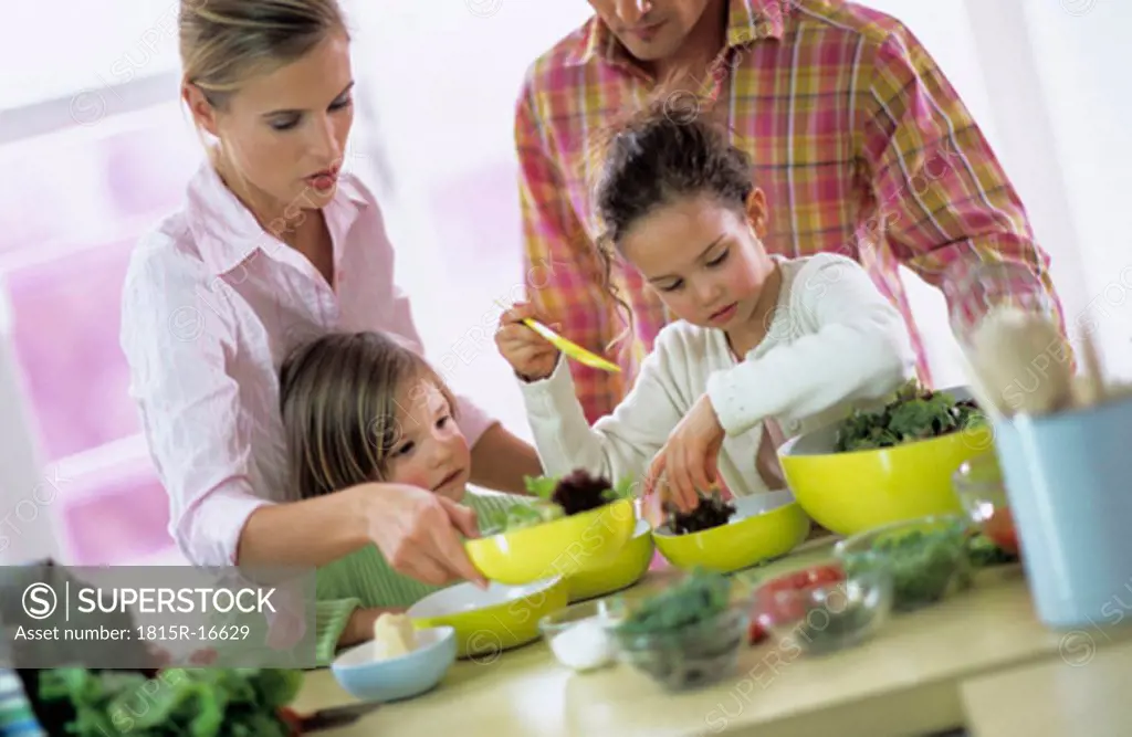 Family in kitchen preparing salad, children (4-7)