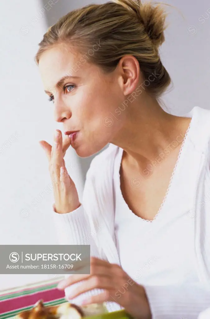 Woman licking her fingers