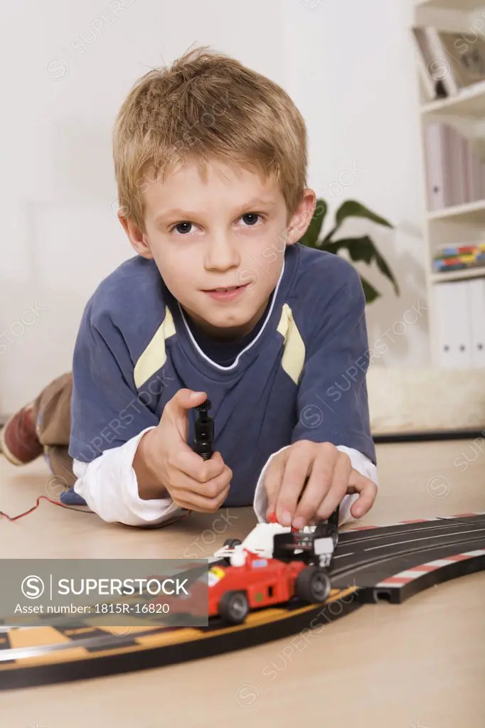 Child (7-9) playing with toy cars