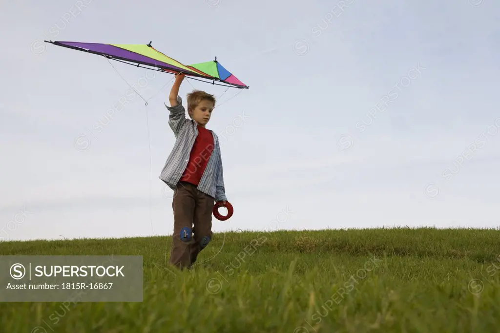 Boy (10-12) flying kite