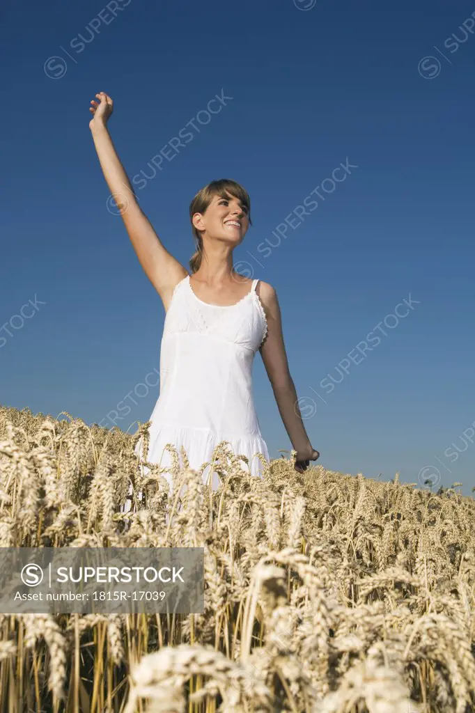 Germany, Bavaria, Young woman standing in field