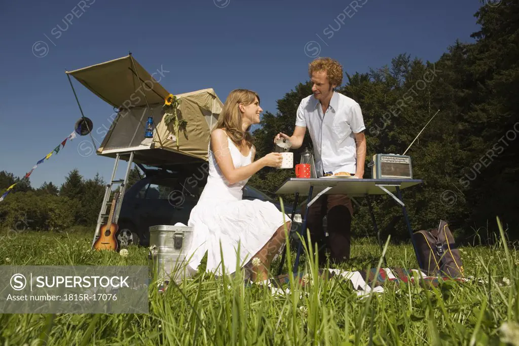 Germany, Bavaria, Young couple having breakfast