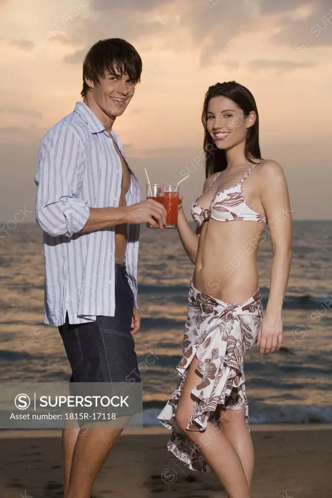 Asia, Thailand, Young couple having drink, portrait