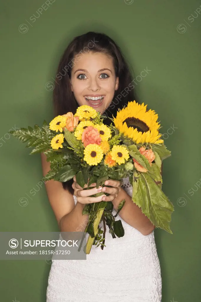 Young woman holding bouquet of flowers, portrait