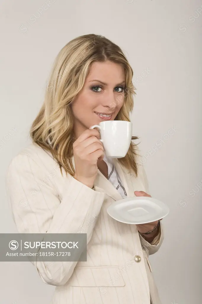 Young woman drinking a cup of coffee, portrait