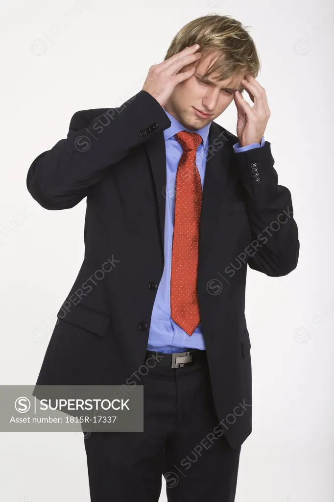 Young businessman with hands to head