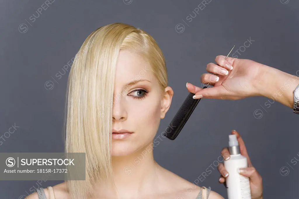 Hair stylist styling woman's hair