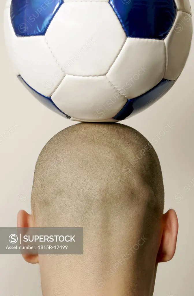 Man with soccer ball on head, rear view, close-up