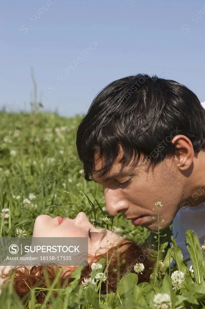 Young couple in meadow, close-up