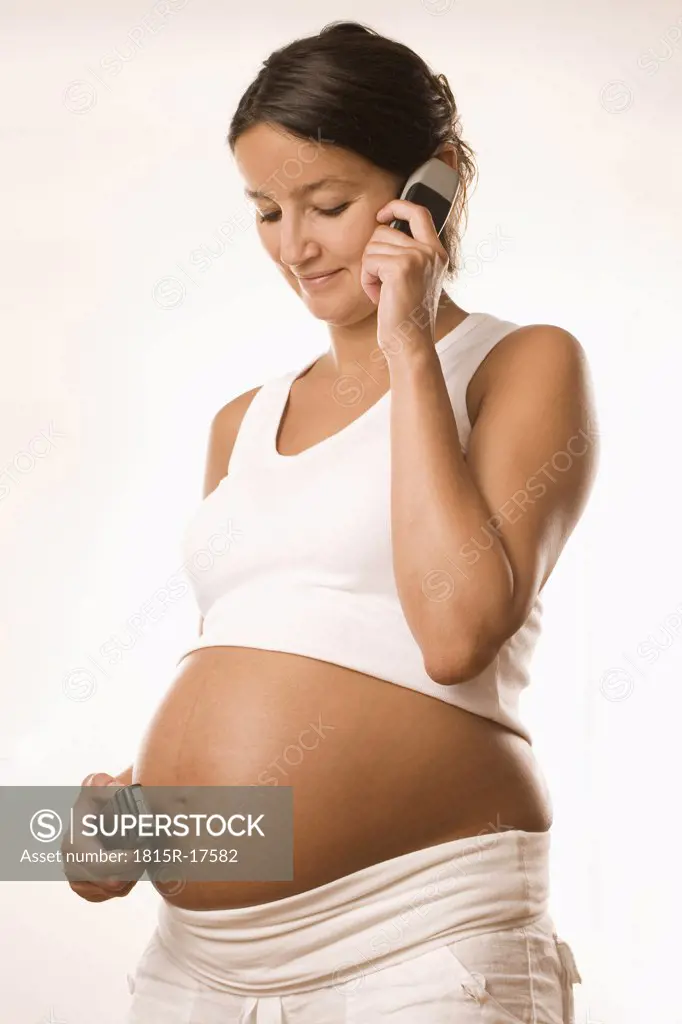 Pregnant woman with mobile phones, close-up