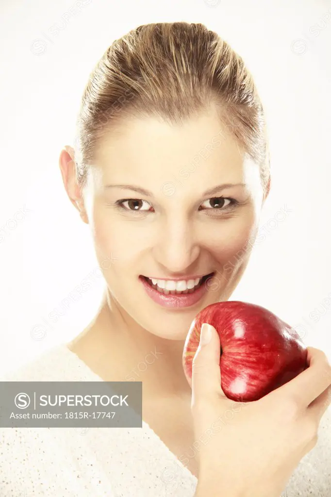 young woman holding apple