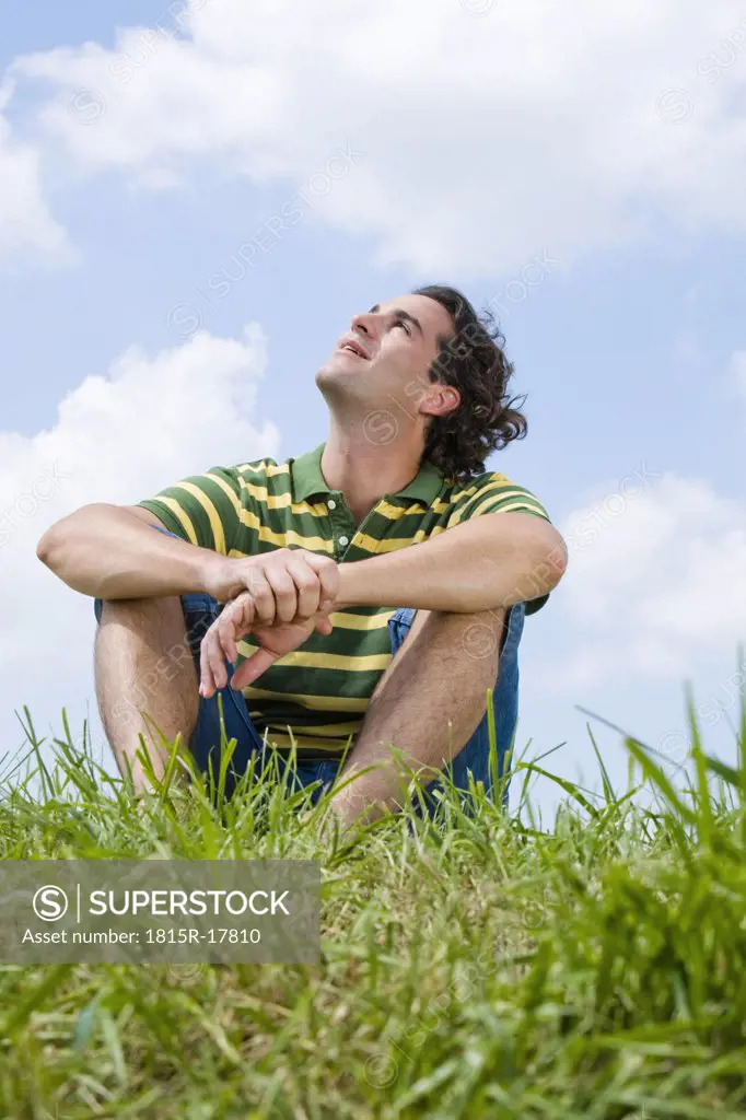 Man sitting in meadow, close-up