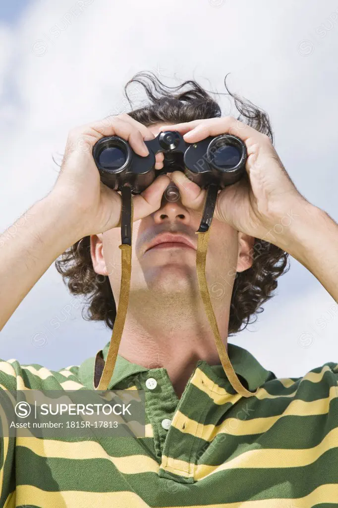 Man using binoculars, close-up