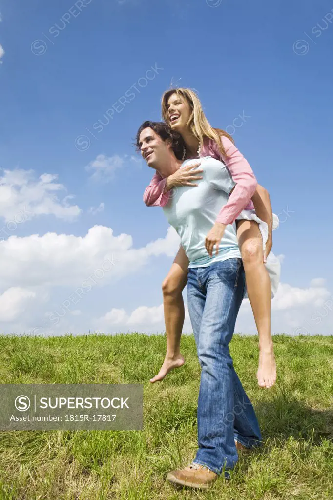 Man carrying woman piggyback