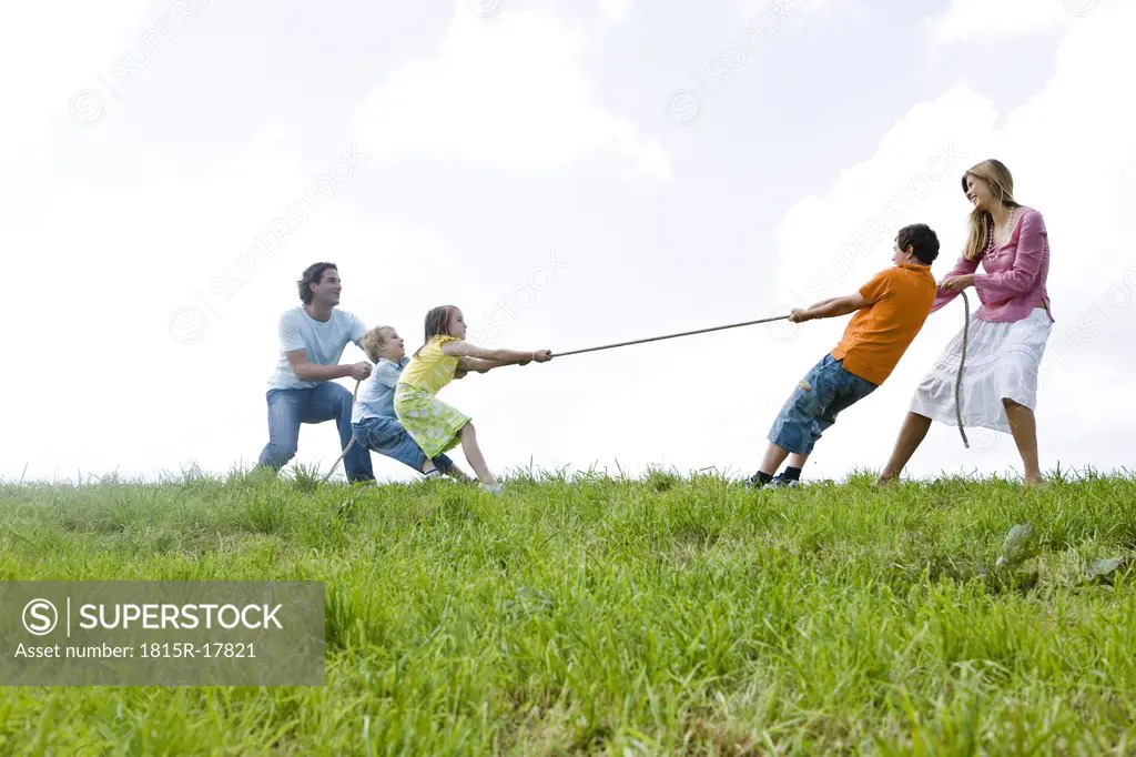 Family pulling rope, close-up