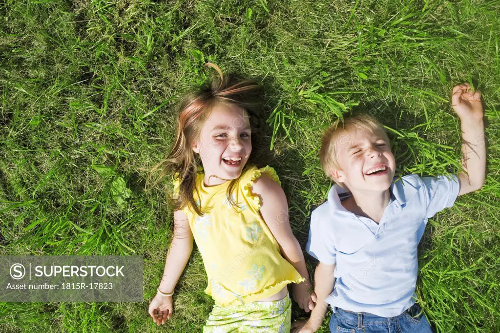 Girl and boy lying in meadow