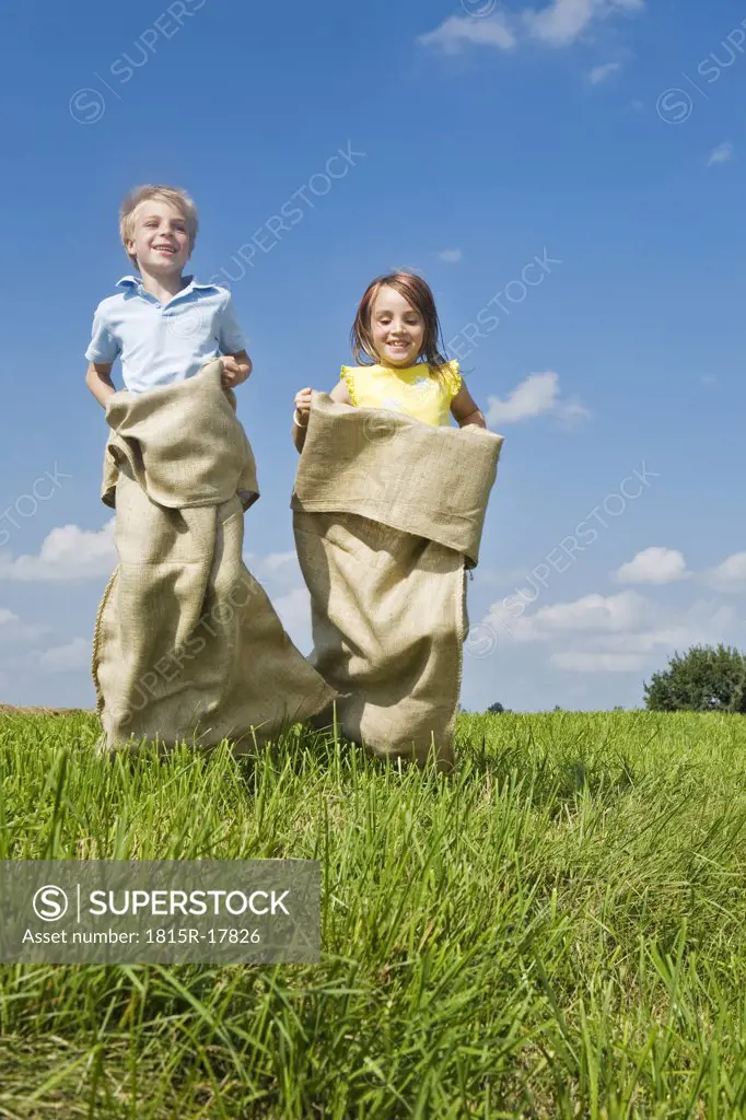 Boy and girl sack racing