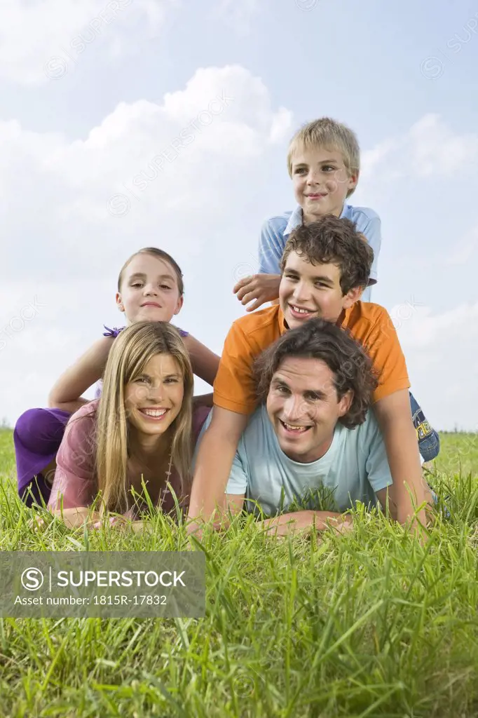 Family lying in meadow