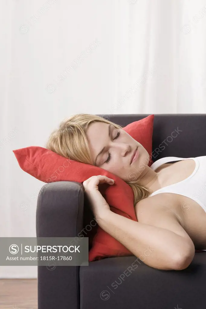 Blonde woman on sofa, sleeping, portrait