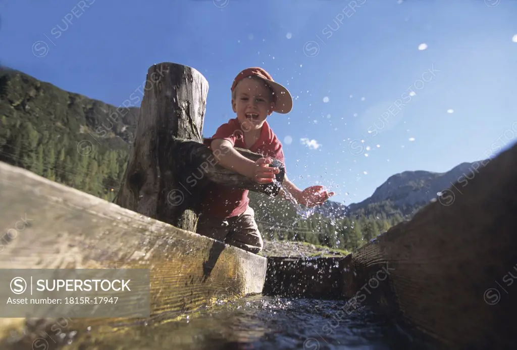 Boy playing at a watering place