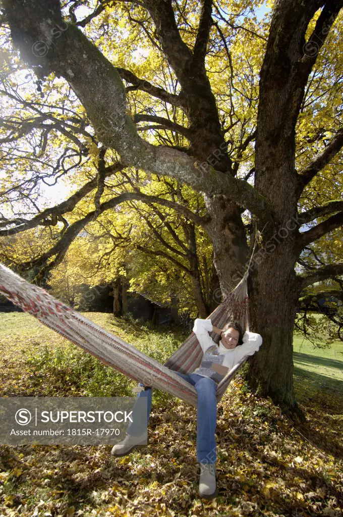 Woman lying in hammok, autumn