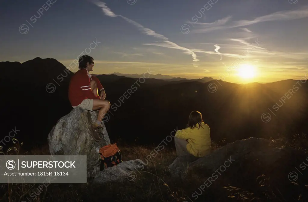 Couple watching sunset in mountains