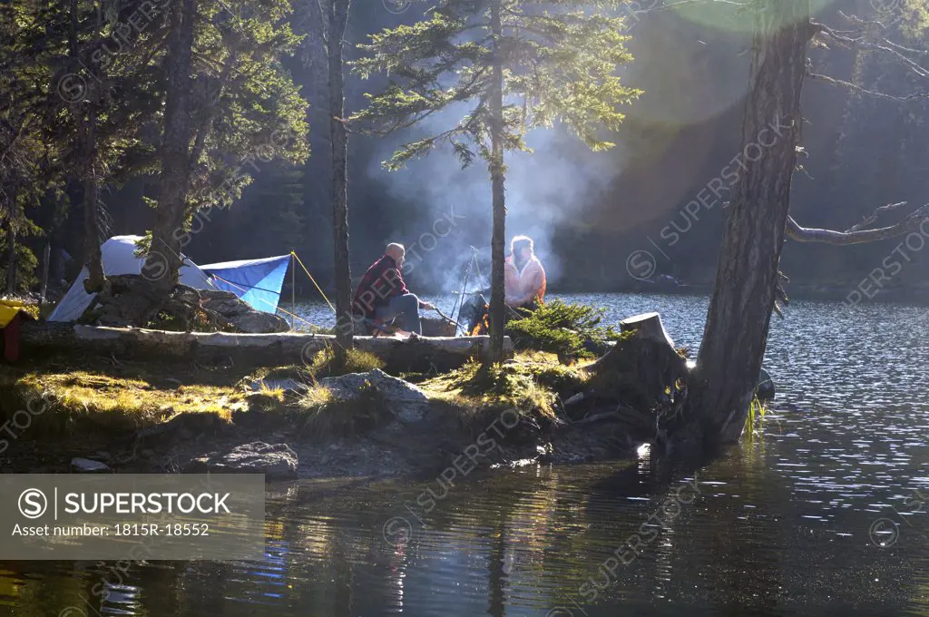 Man and woman camping on small island