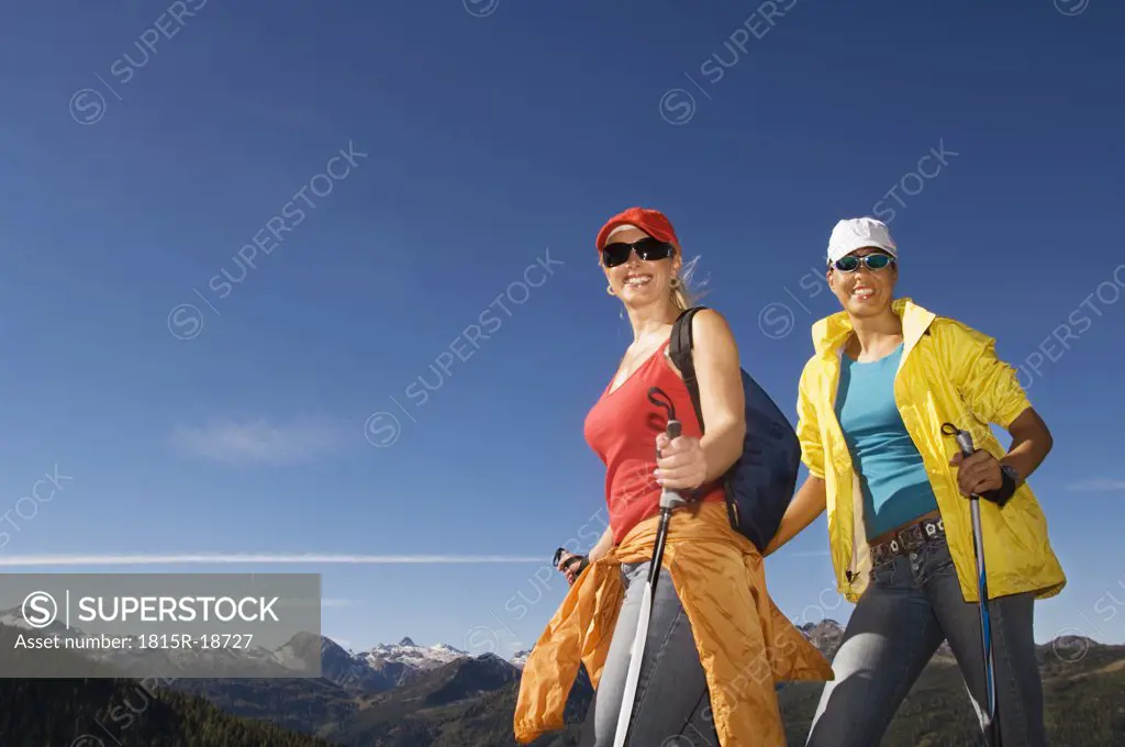 Two women in mountains, nordic walking