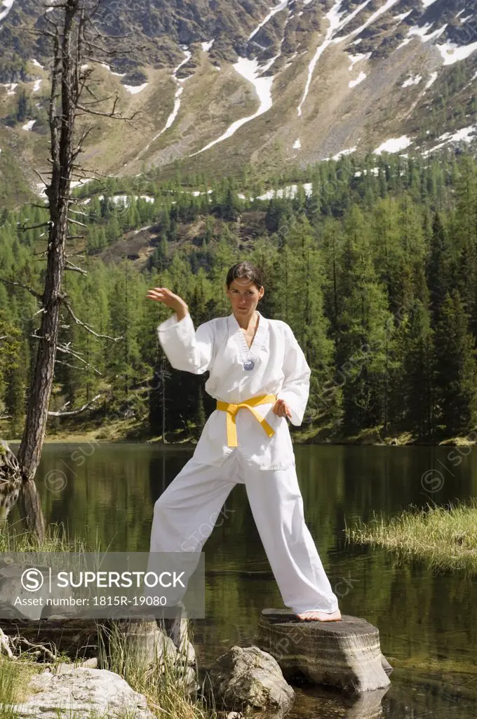 Young woman practicing tae kwon do
