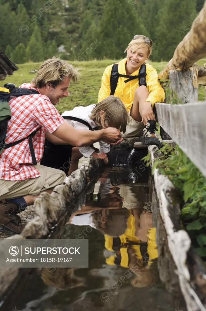 Austria, Salzburger Land, couple with son (8-9) at trough