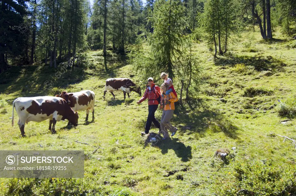 Austria, Salzburger Land, couple with daughter (6-7) hiking