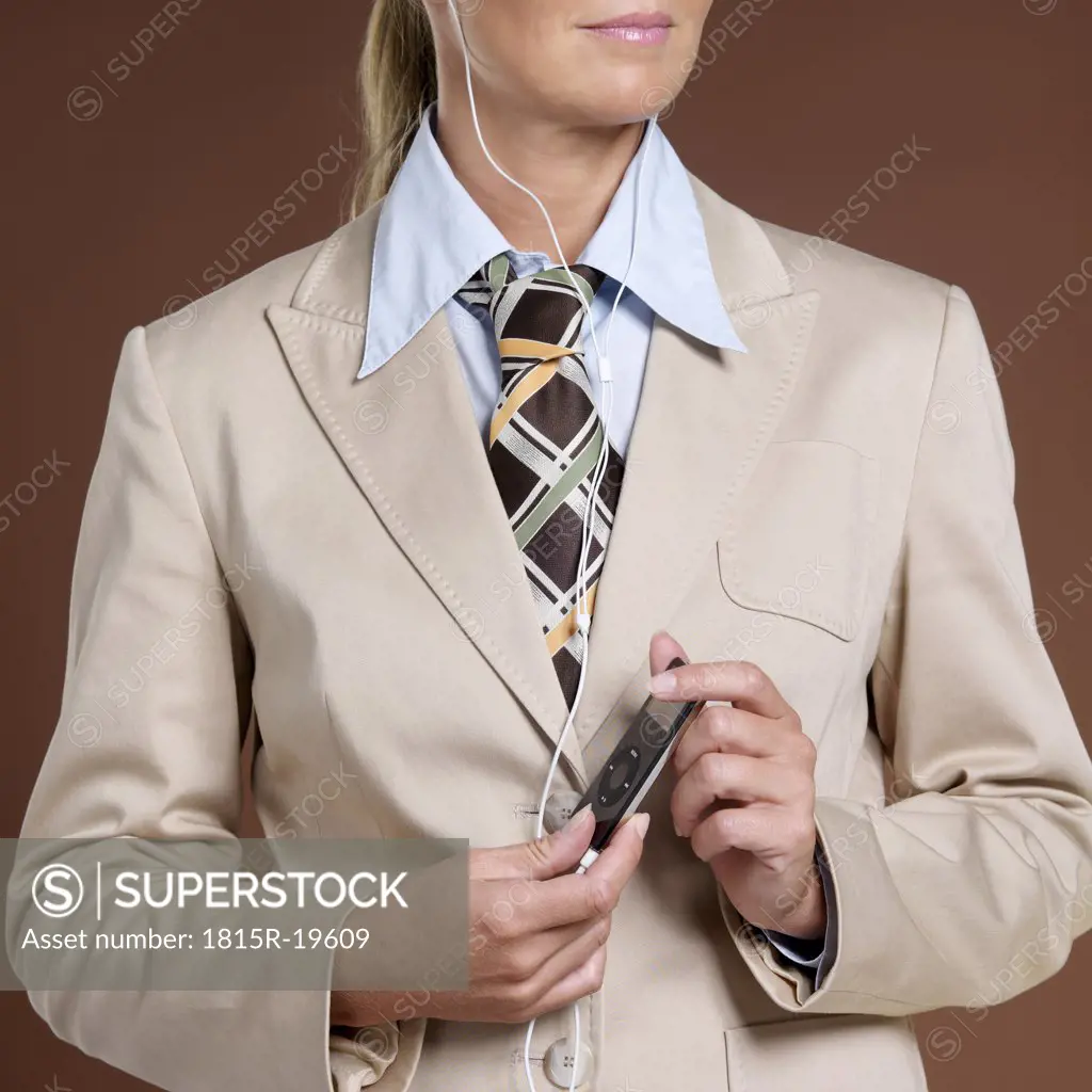 Businesswoman holding mp3 player, close-up