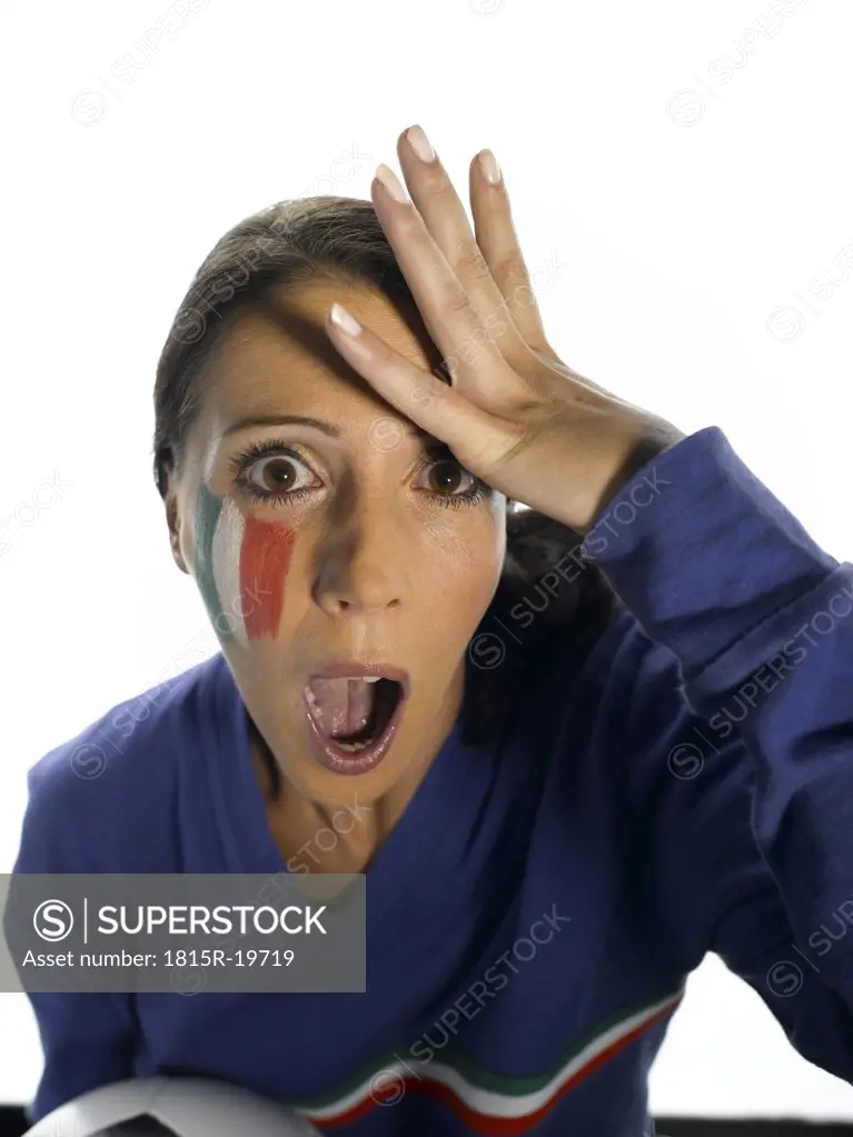 Woman with Italian Flag painted on her face, head in hands, holding soccer ball