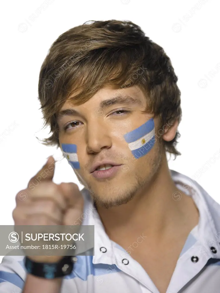 Young man with Argentina's flag painted on face, close-up