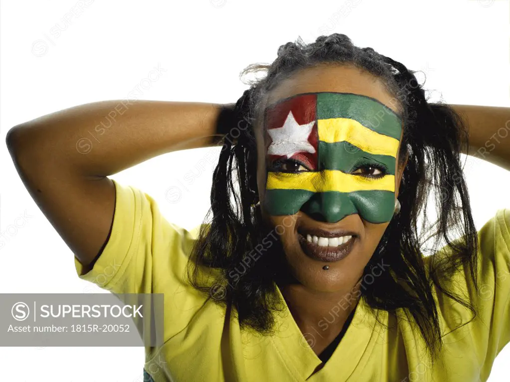Woman with Togo flag painted on face, close-up, portrait