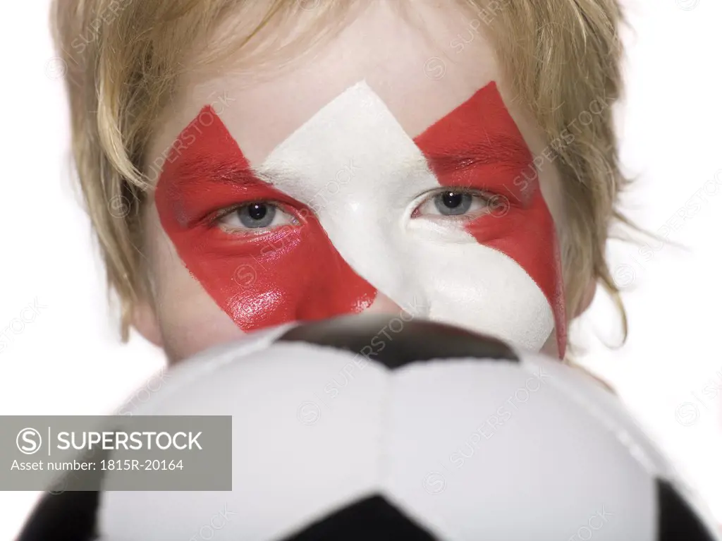 Boy (10-12), Austrian football fan, holding football, close-up