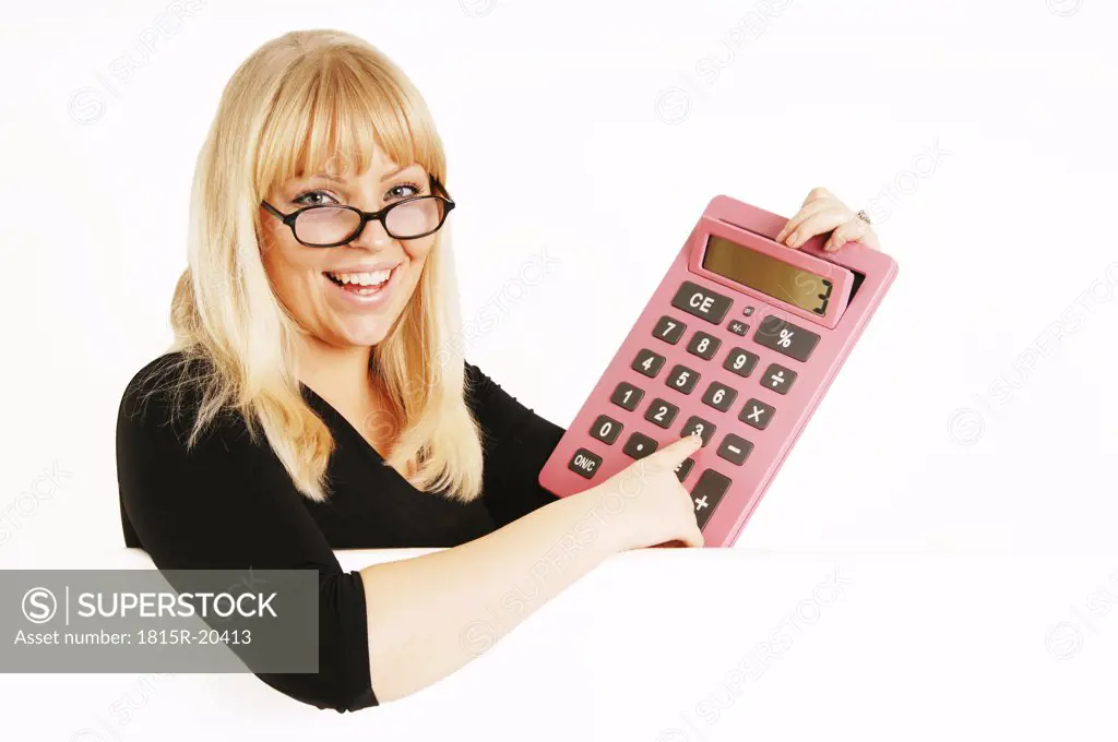 Woman holding calculator, portrait