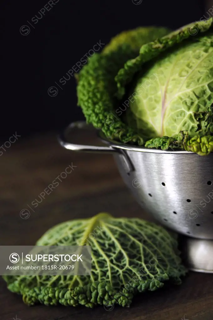 Savoy cabbage in strainer, close-up