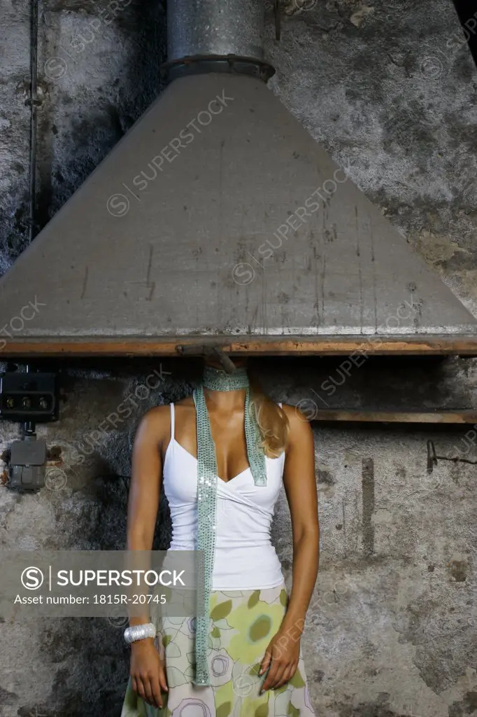 Young woman hiding face under chimney