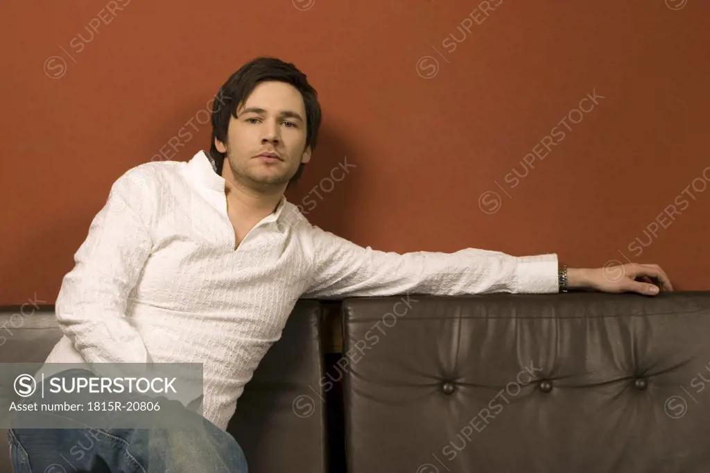 Young man sitting, portrait
