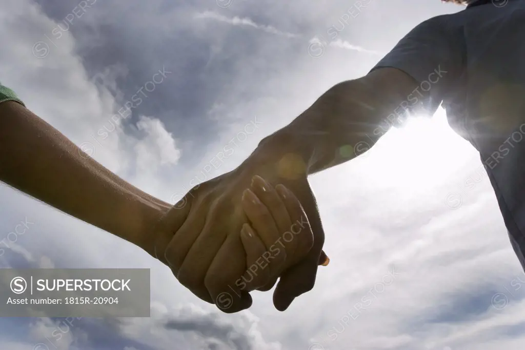 Man and woman holding hands, close-up