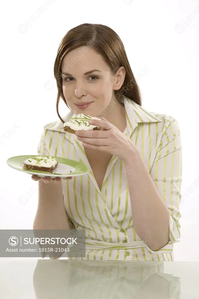 Woman eating bread, portrait