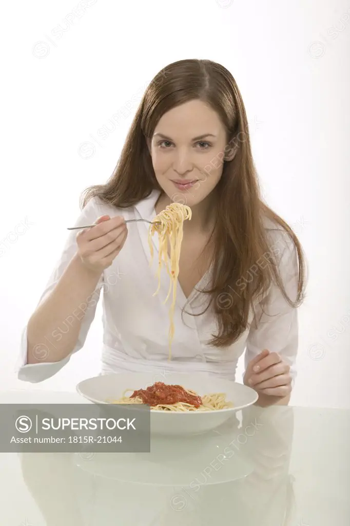 Woman eating noodles, portrait