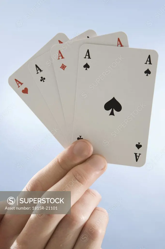 Hand holding aces, close-up