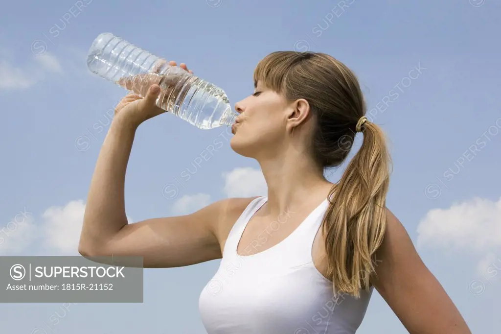 Young woman drinking water, portrait